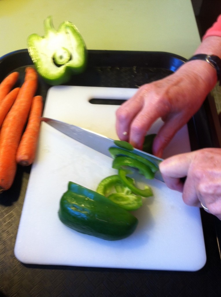 Hands cutting vegetables